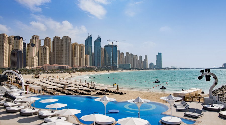 Dubai beachfront with luxury beach club and city skyline